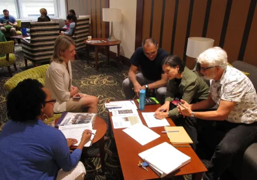 A group of people sitting around a table.