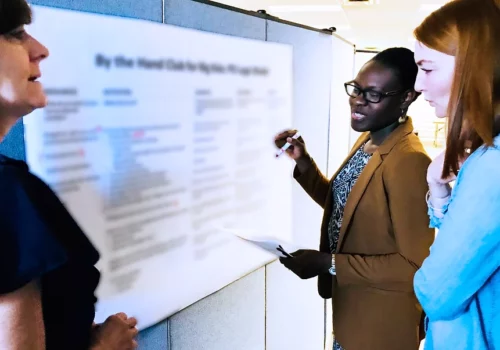 A man standing in front of a white board.